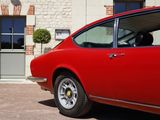 a red car that is parked in front of a building