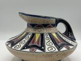 a picture of a vase with a handle on a table