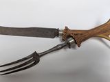 a knife and fork with antlers attached to it