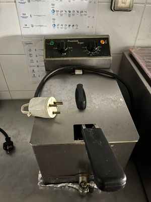an image of a kitchen with a fryer and other appliances