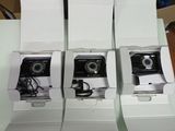 three cameras are sitting in a white box on a table