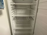 an empty refrigerator in the corner of a room