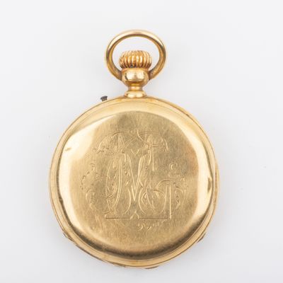 an antique gold pocket watch on a white surface with a white background