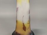a glass vase with a yellow and white design on it