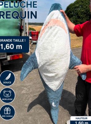 a man standing next to a large shark that is being held by a man