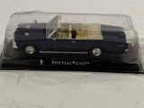 a toy car in a plastic case on a white surface