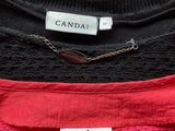 three sweaters are stacked on top of each other on a table