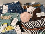 a pile of clothes and other items that are on display