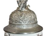 an image of a beer mug with a statue on top of it