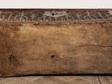 an old wooden chest sitting on top of a wooden floor next to a wall