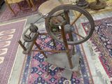 a spinning wheel sitting on a rug in a room