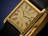 a close up of a watch with roman numerals on the face