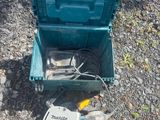 a green box with a tool in it on the ground
