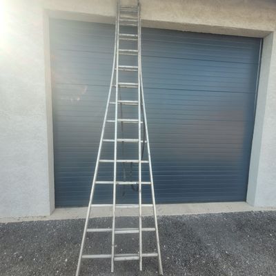 an image of a ladder leaning up against a garage door