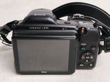 a camera that is sitting on a table with a strap around it