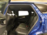 a blue truck with the door open and the passenger seat down