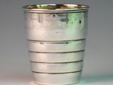 a silver cup that is sitting on a table