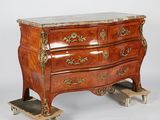 a wooden chest of drawers with a marble top