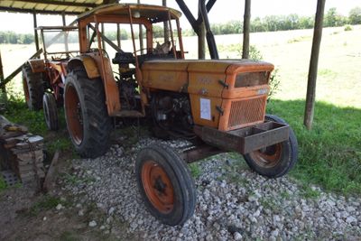 a tractor that is parked under a shelter