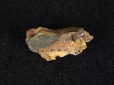 a close up of a piece of rock on a black surface
