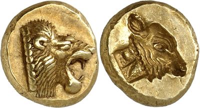 a close up of two gold coins with animals on them