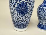 two blue and white vases sitting next to each other