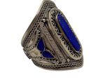 a close up of a ring with a blue stone in it