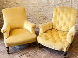 pair of yellow chairs sitting next to each other on a brick floor