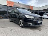 a black ford c - max parked in front of a building