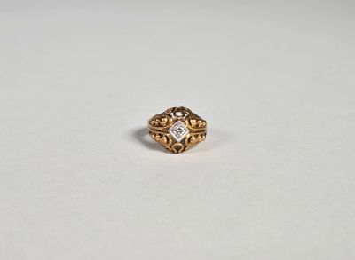 gros plan d'une bague en or sur une surface blanche