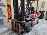 a red forklift truck parked in a warehouse