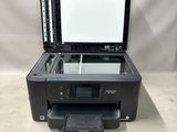 a printer sitting on top of a counter next to a white background