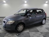 a picture of a small grey car parked in a garage