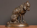 bronze statue of a dog on a wooden table