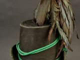 a brown hat with a feather on top of it