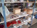 many bowls and pans on the shelves in the kitchen
