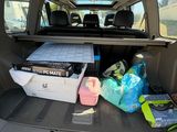 a trunk of a car with a cooler in the back