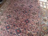 a large oriental rug on a wooden floor in a room