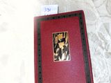 a red book sitting on top of a white bed