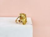 a gold ring sitting on top of a marble block