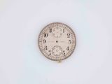 a clock that is sitting on a white surface
