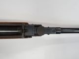 a rifle with a wooden handle and a metal barrel