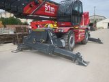 a crane that is sitting on the ground in front of a building