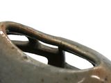 a close up of a vase with a handle on it