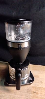 a coffee maker that is sitting on a wooden table