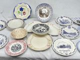 many plates and bowls on a table with a white table cloth