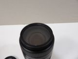a camera lens sitting on top of a table next to a cell phone