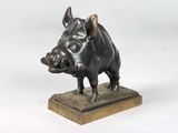 bronze sculpture of a boar on a wooden base