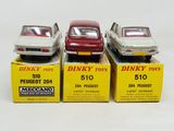 three toy cars are sitting on boxes on a white surface