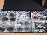 many pairs of glasses in a box on a table